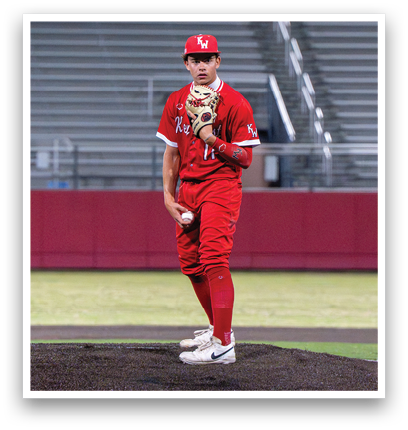 A baseball player in a red uniform is standing on a mound. Description generated by AI
