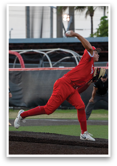 A baseball player in a red jersey is pitching a ball. Description generated by AI
