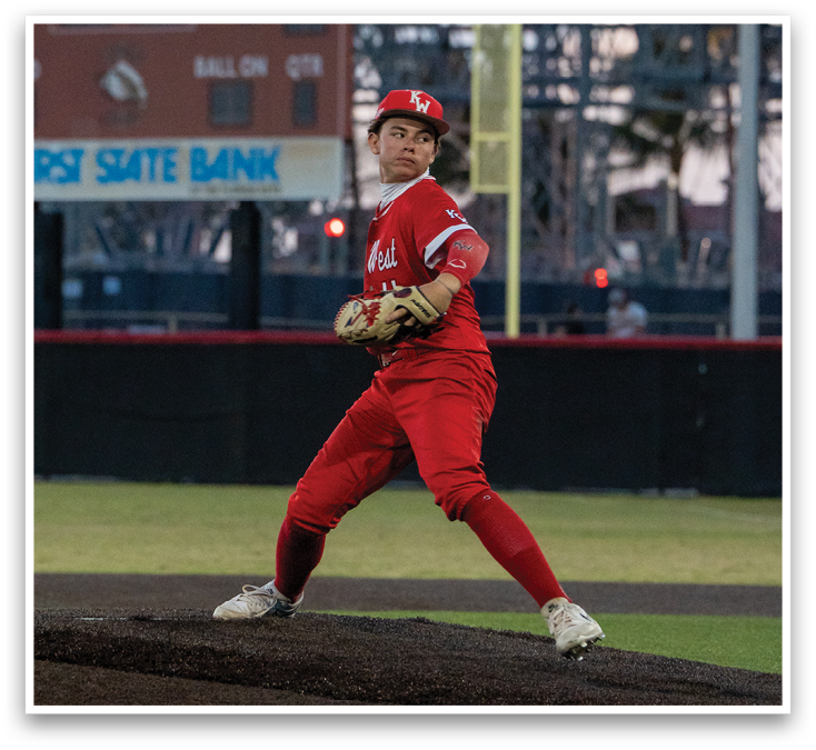 A baseball player in a red jersey and red pants is pitching a ball. Description generated by AI