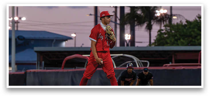 A baseball player in a red uniform stands on a mound. Description generated by AI