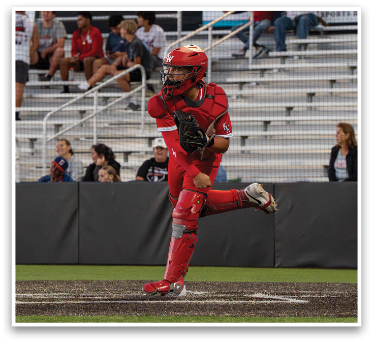 A baseball player in a red uniform is throwing a ball. Description generated by AI