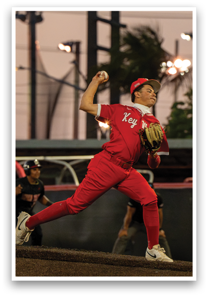A person in a red shirt and red pants is throwing a ball. Description generated by AI