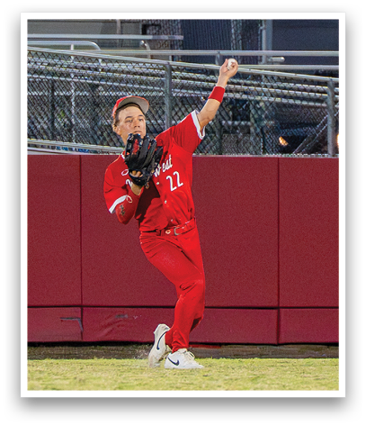 A baseball player in a red uniform is throwing a ball. Description generated by AI