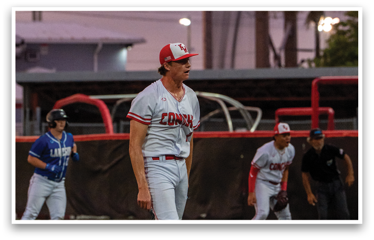 A baseball player wearing a red and white uniform stands on the pitcher's mound. Description generated by AI