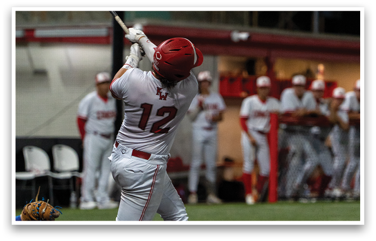 A baseball player is swinging a bat at a ball. Description generated by AI