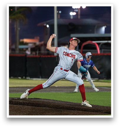 A baseball player in a grey and red uniform is pitching a ball. Description generated by AI