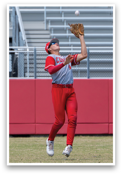 A baseball player wearing a red jersey catching a ball. Description generated by AI