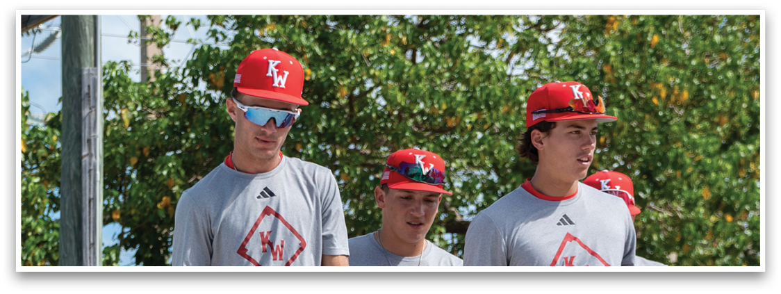 A group of baseball players walking on a dirt road. Description generated by AI