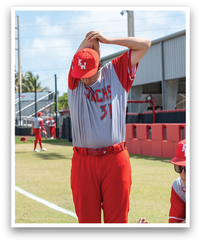 A man wearing a red baseball uniform with the number 5 on it. Description generated by AI