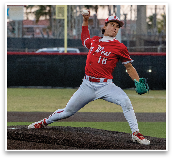 A baseball player in a red shirt and white pants is throwing a ball. Description generated by AI