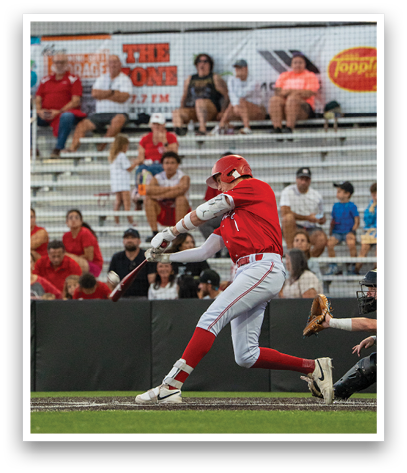 A baseball player in a red and white uniform is swinging a bat. Description generated by AI