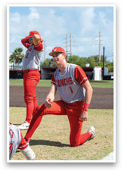 A baseball player wearing a red and white uniform. Description generated by AI