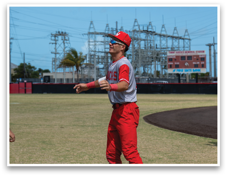 A group of men wearing red and grey baseball uniforms. Description generated by AI