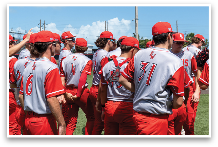 A group of baseball players wearing red and grey uniforms. Description generated by AI