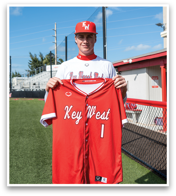 A man wearing a red and white baseball jersey with the number 1 on it. Description generated by AI