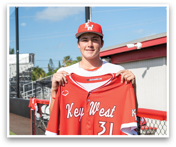 A man wearing a red jersey with the number 33 on it. Description generated by AI