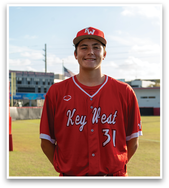 A man wearing a red baseball jersey with the number 31 on it. Description generated by AI