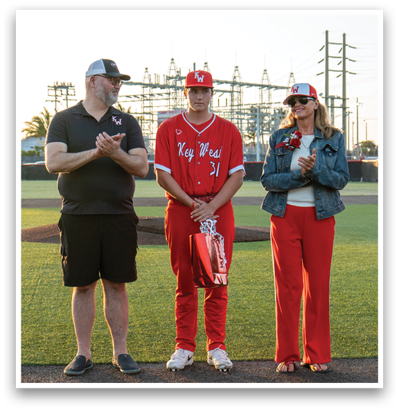 A group of people standing on a baseball field. Description generated by AI