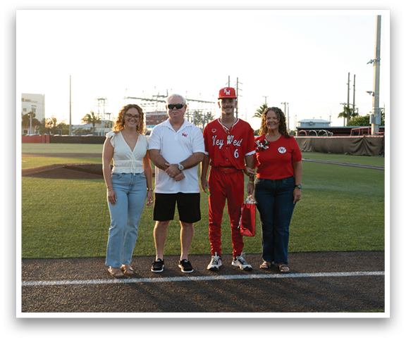 A group of people standing on a baseball field. Description generated by AI