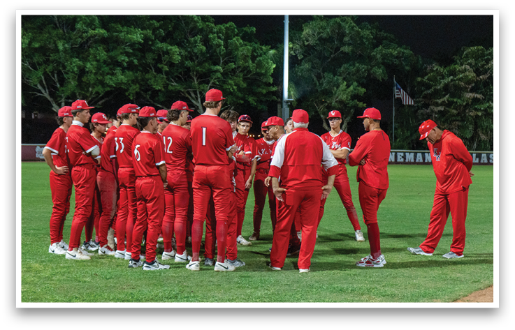 A group of people wearing red and white uniforms. Description generated by AI