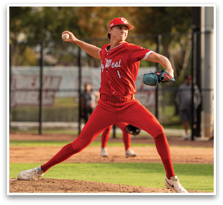 A man in a red baseball uniform is pitching a ball. Description generated by AI