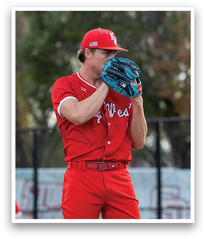 A man wearing a red baseball uniform is standing on a mound. Description generated by AI