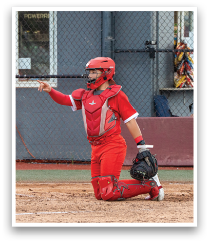 A baseball player in a red uniform is kneeling on the ground. Description generated by AI