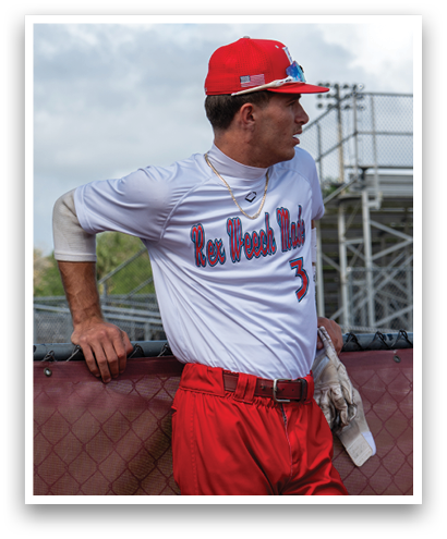 A man wearing a red baseball cap and red pants. Description generated by AI
