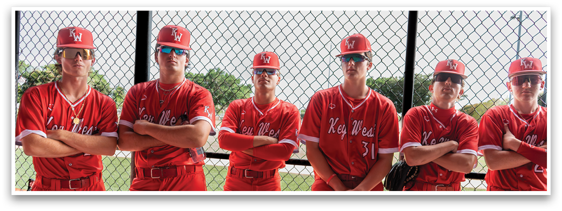 A group of baseball players wearing red and white uniforms. Description generated by AI