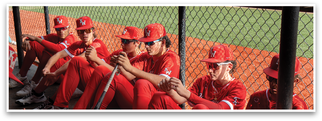 Baseball players sitting on bench. Description generated by AI