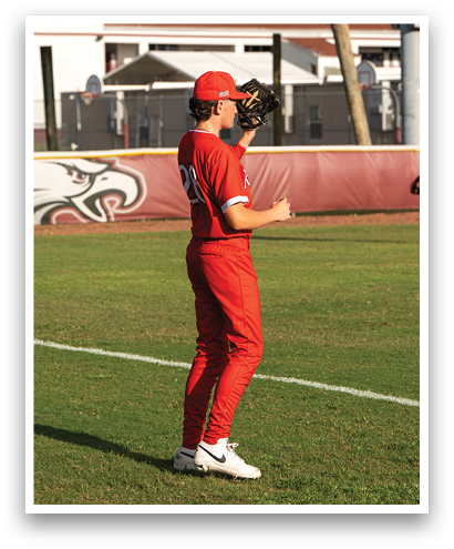 A baseball player wearing a red uniform and a red hat. Description generated by AI