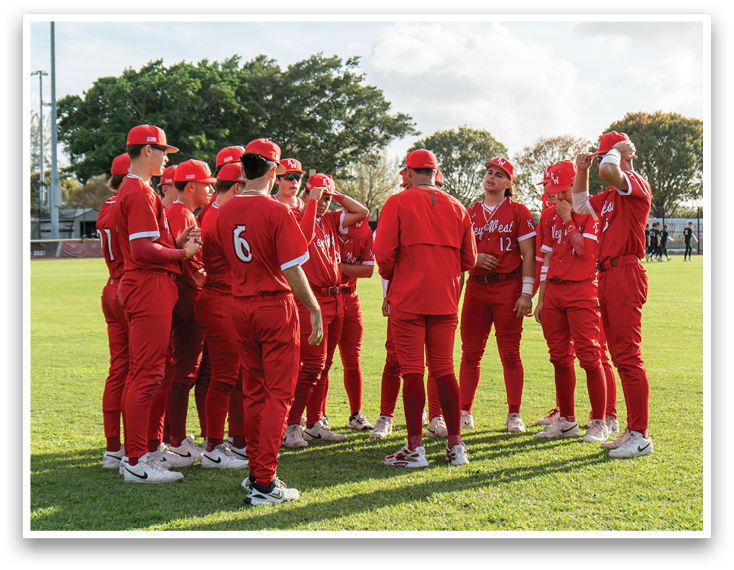 A group of baseball players wearing red uniforms. Description generated by AI