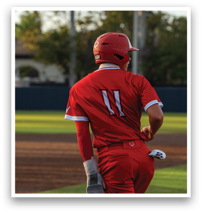 A baseball player in a red jersey with the number 11 on the back. Description generated by AI