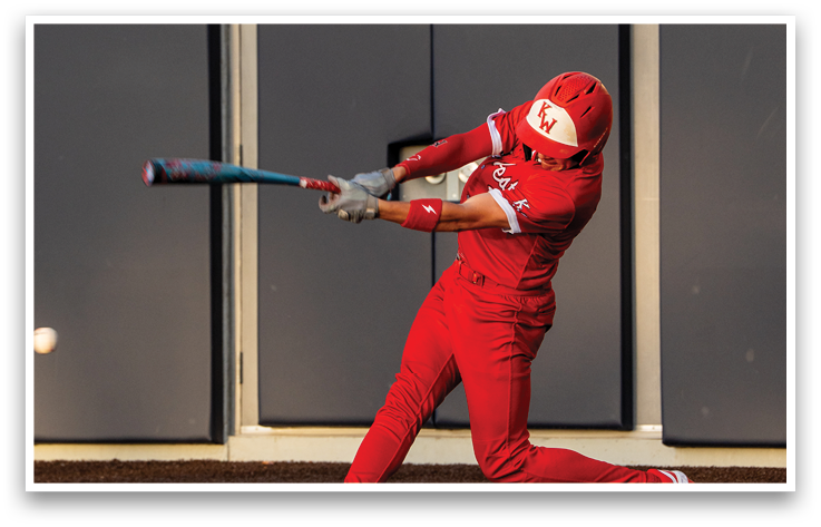 A baseball player in a red uniform is swinging a bat. Description generated by AI
