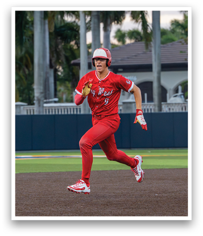 A baseball player wearing a red jersey and red pants running on the field. Description generated by AI