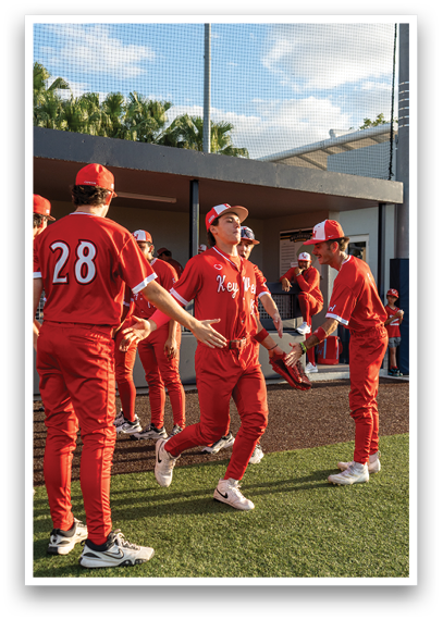 A group of people wearing red and white uniforms. Description generated by AI