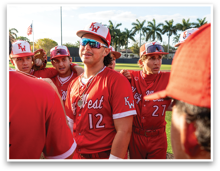 A group of baseball players wearing red jerseys. Description generated by AI