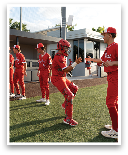 Baseball players in red uniforms. Description generated by AI