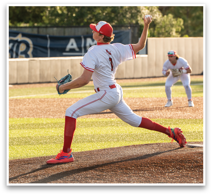 A baseball player in a white uniform is pitching a ball. Description generated by AI