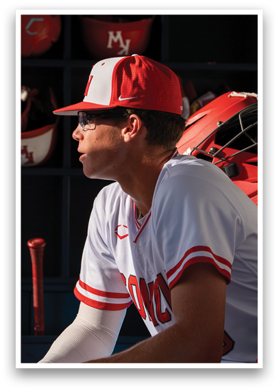A baseball player wearing a red and white hat and shirt. Description generated by AI