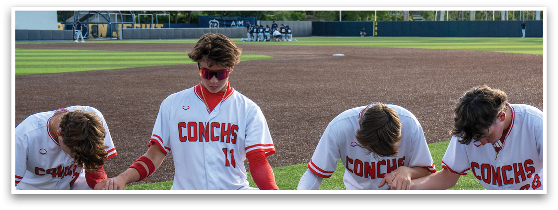 A group of baseball players kneeling on the field. Description generated by AI