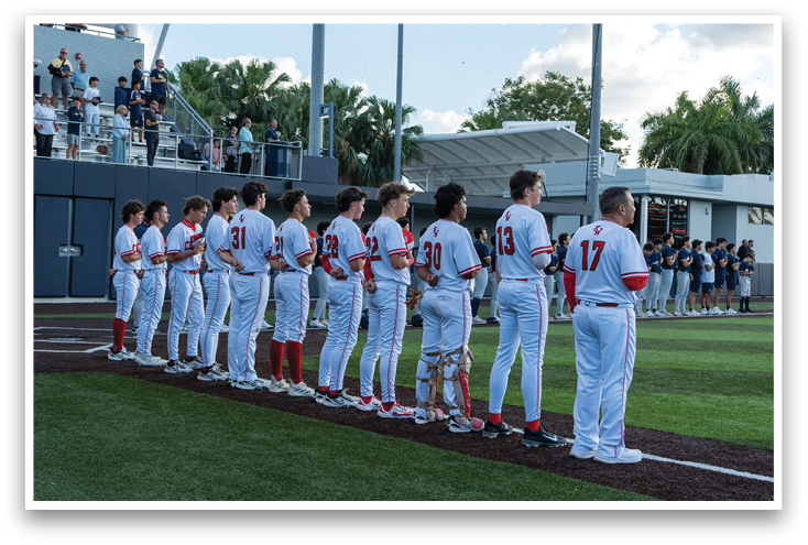 Baseball players standing on a field. Description generated by AI