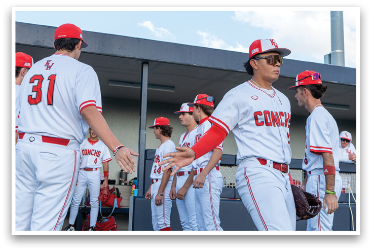 Baseball players wearing red and white uniforms. Description generated by AI