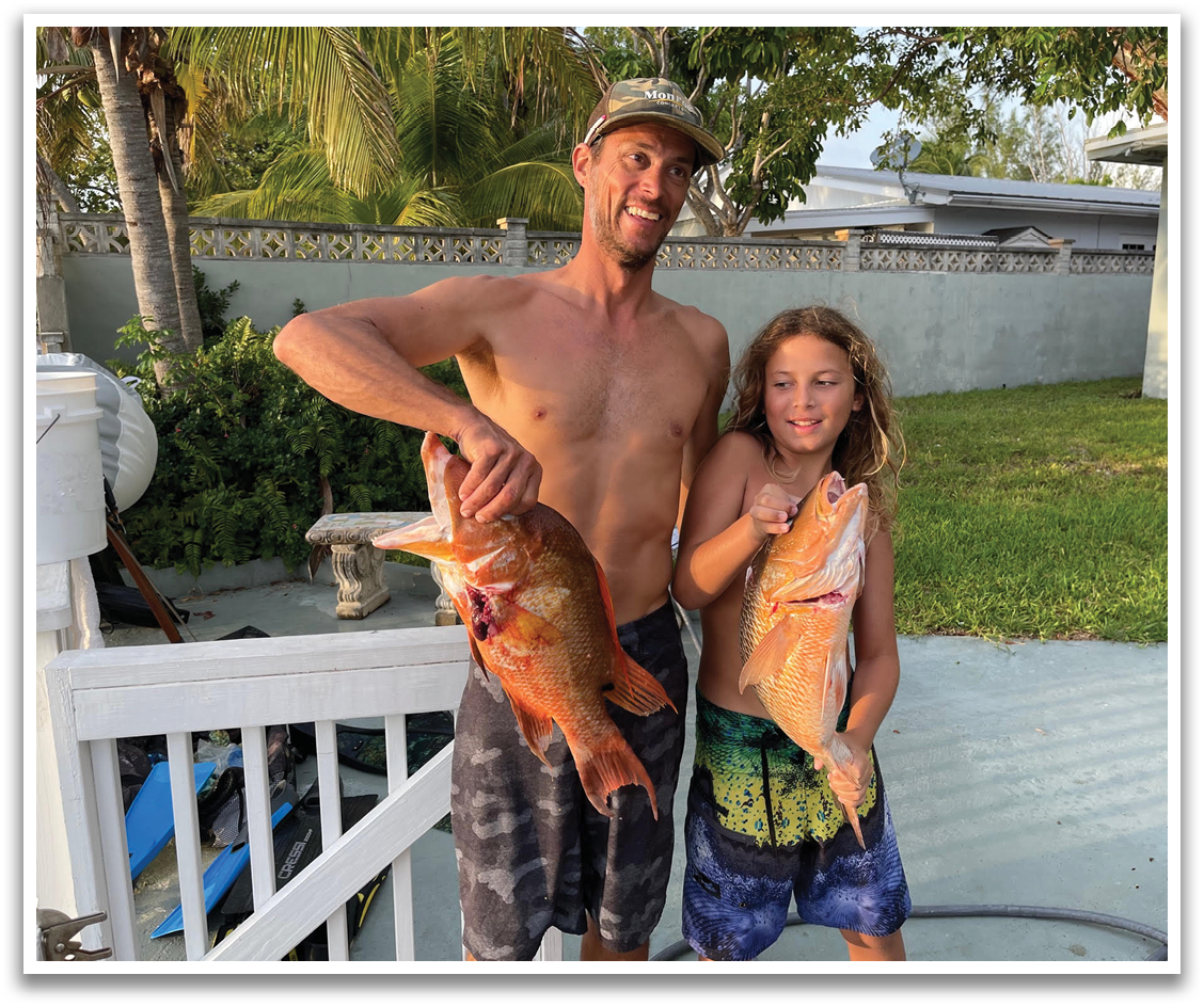 A man and a young boy are holding up fish they caught. AI generated content
