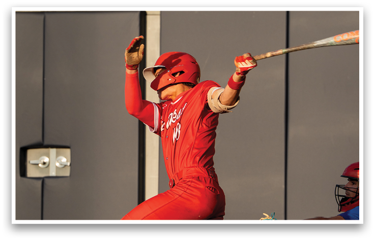 A baseball player in a red uniform is swinging a bat. Description generated by AI