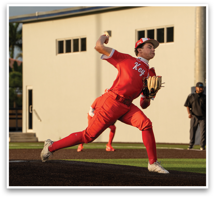 A man in a red shirt and red pants is throwing a baseball. Description generated by AI