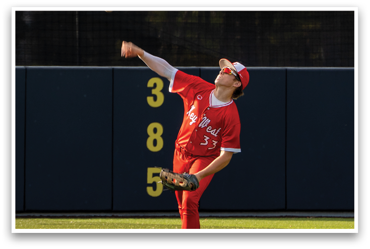 A baseball player in a red uniform is throwing a ball. Description generated by AI