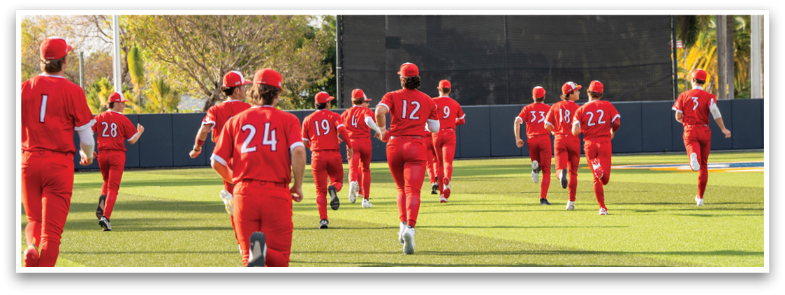 A group of people wearing red and white uniforms are walking on a field. Description generated by AI