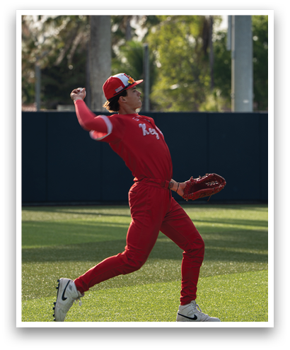 A baseball player wearing a red jersey and red pants is throwing a ball. Description generated by AI