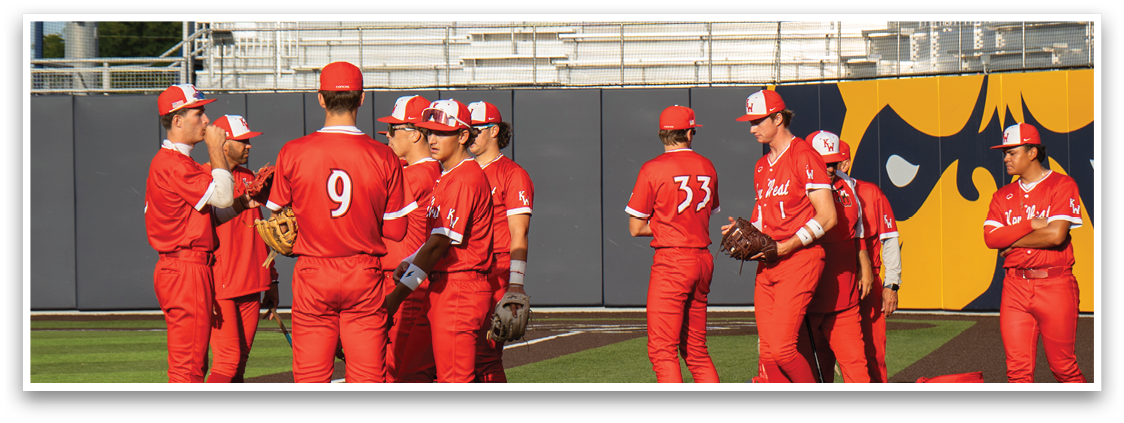 A group of baseball players wearing red uniforms. Description generated by AI